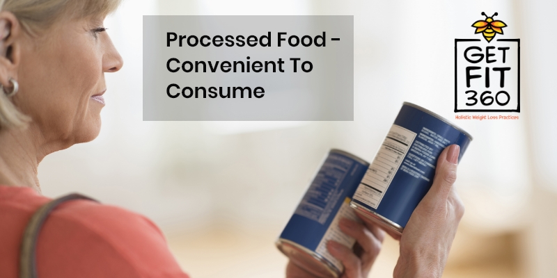 A middle-aged woman comparing the label on containers of processed food-health-risks